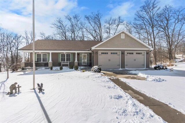 view of front of property with a porch and a garage