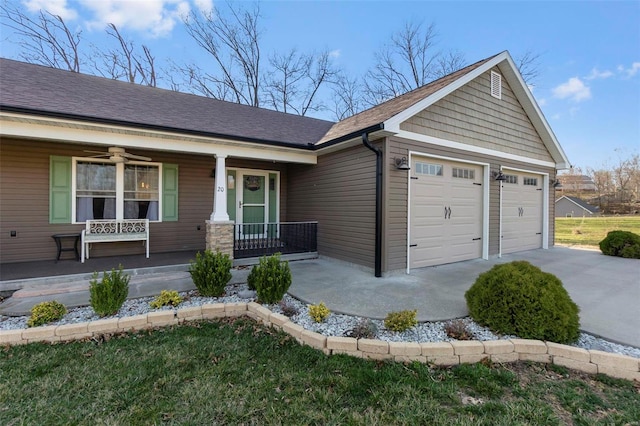 view of front facade with a ceiling fan, driveway, roof with shingles, an attached garage, and covered porch