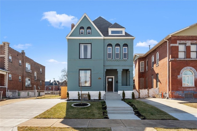 view of front of home featuring fence