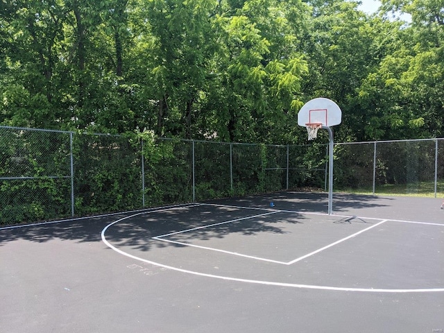 view of basketball court with community basketball court and fence