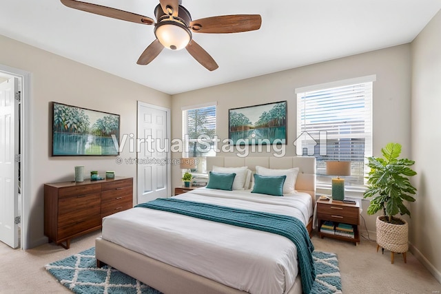 bedroom with light carpet, baseboards, and a ceiling fan