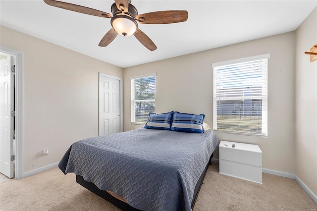 carpeted bedroom featuring a ceiling fan and baseboards