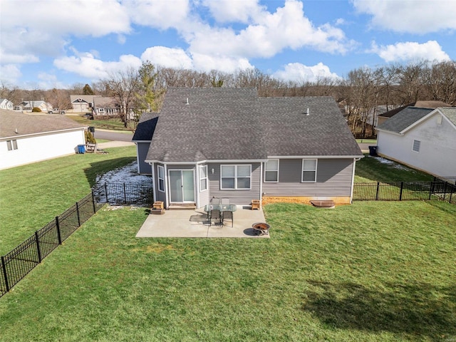 rear view of property featuring a patio, a lawn, a fenced backyard, and roof with shingles