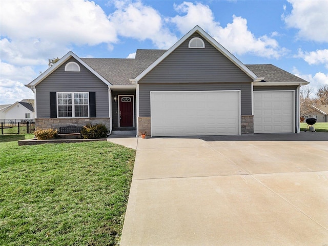 ranch-style home with an attached garage, a front yard, fence, stone siding, and driveway