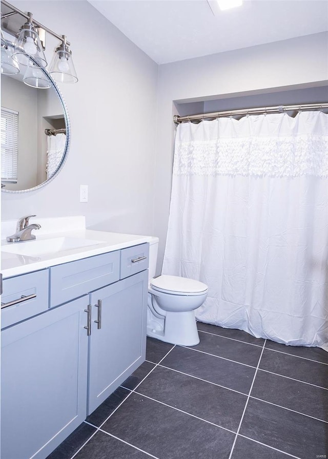 full bathroom with toilet, tile patterned flooring, and vanity