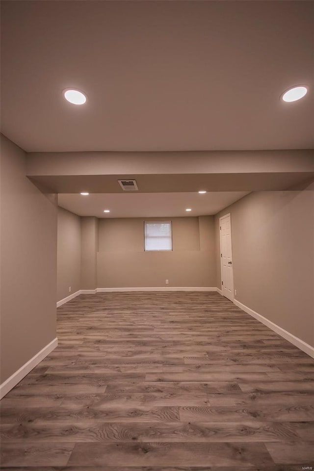 below grade area with baseboards, visible vents, wood finished floors, and recessed lighting