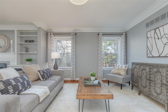 living area featuring visible vents, ornamental molding, built in features, wood finished floors, and baseboards