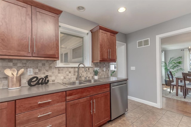 kitchen with visible vents, a sink, backsplash, light tile patterned floors, and dishwasher