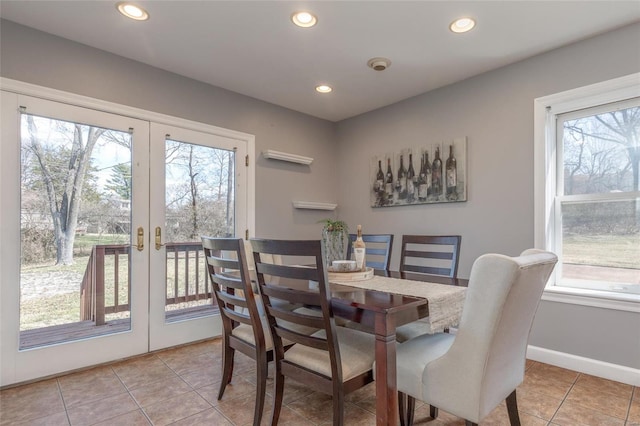 dining room featuring a wealth of natural light, french doors, light tile patterned flooring, and recessed lighting