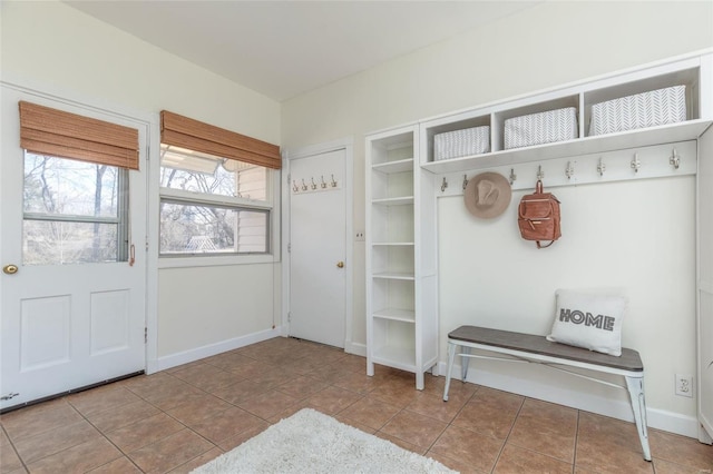 mudroom with baseboards and tile patterned flooring