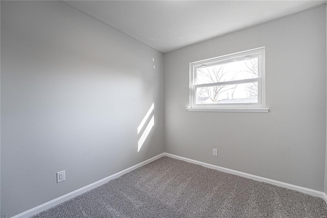 carpeted empty room with baseboards