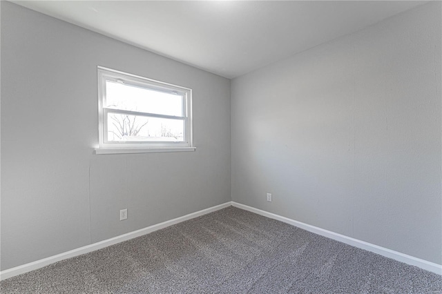 empty room featuring baseboards and carpet floors