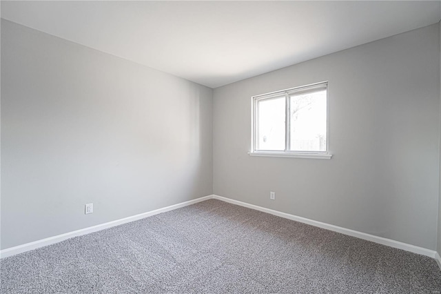 carpeted spare room with baseboards