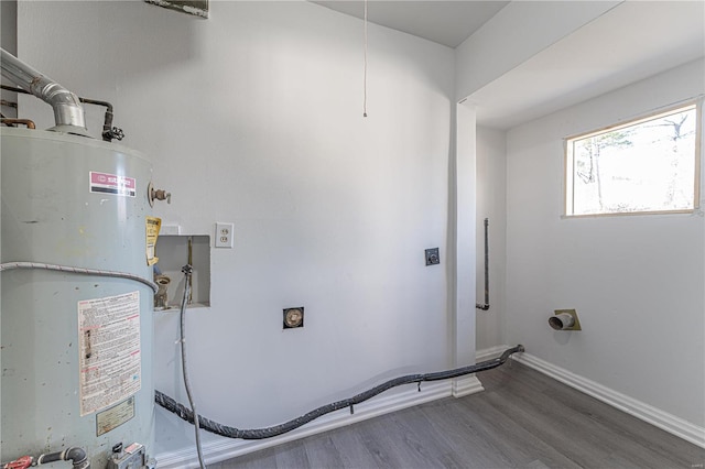 laundry room with baseboards, gas water heater, laundry area, wood finished floors, and hookup for an electric dryer