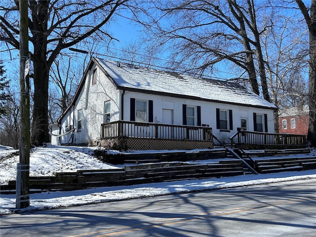 view of front of house with a wooden deck and stucco siding