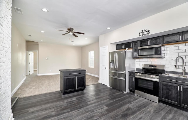 kitchen with a sink, dark cabinets, visible vents, and stainless steel appliances