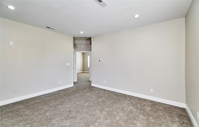 spare room with recessed lighting, baseboards, and visible vents