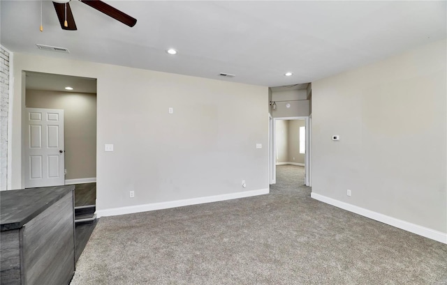 spare room with visible vents, recessed lighting, carpet, and baseboards