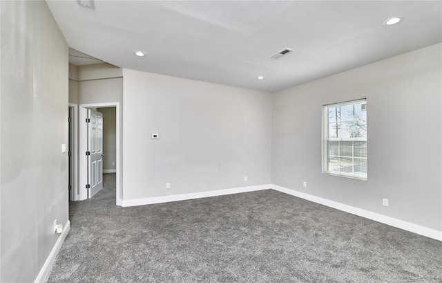 spare room featuring recessed lighting, visible vents, and dark carpet