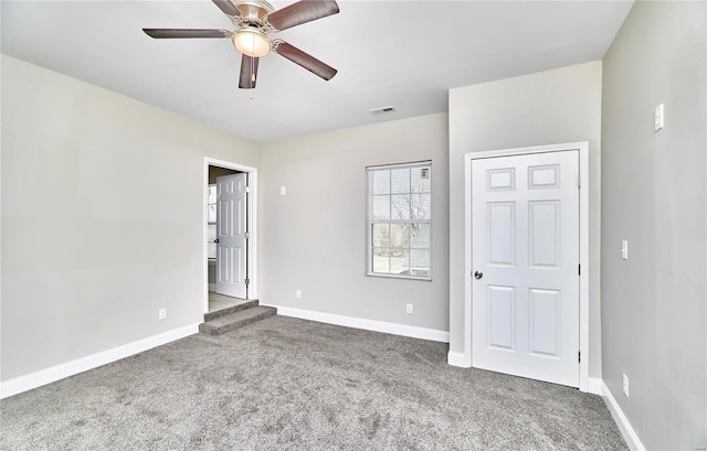 unfurnished bedroom featuring visible vents, baseboards, and carpet