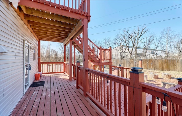 wooden deck featuring stairway and fence