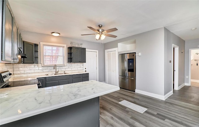 kitchen featuring a sink, backsplash, range with electric stovetop, smart refrigerator, and open shelves