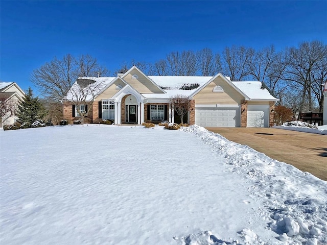 view of front of house featuring a garage, driveway, and brick siding