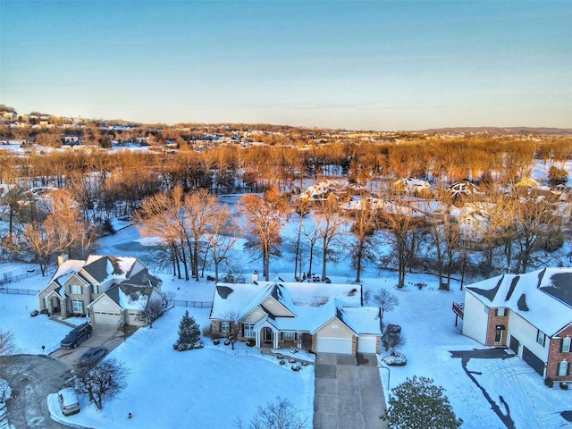 snowy aerial view featuring a residential view