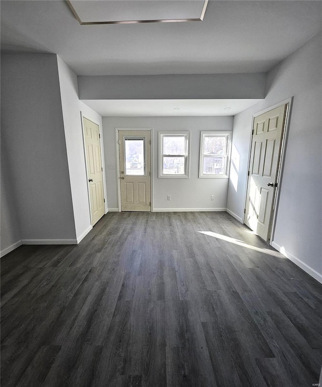 entrance foyer featuring baseboards and dark wood-style floors