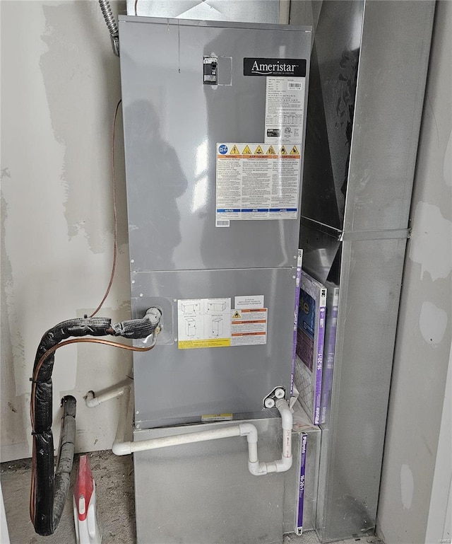 utility room featuring heating unit