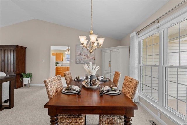 dining area with a wealth of natural light, lofted ceiling, and light carpet