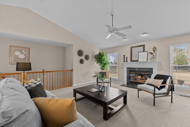 carpeted living area featuring a wealth of natural light, lofted ceiling, visible vents, and a fireplace