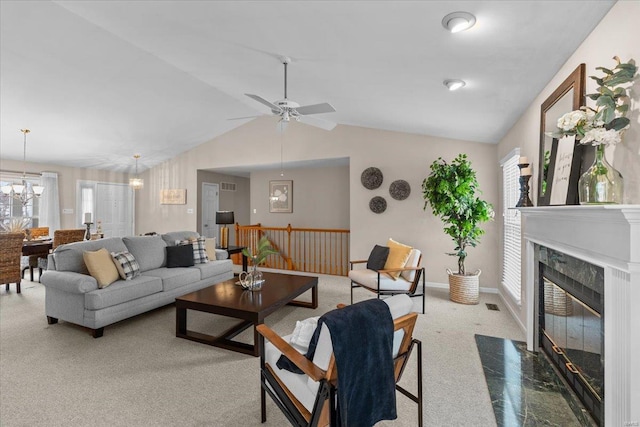 living room featuring carpet floors, a premium fireplace, visible vents, baseboards, and vaulted ceiling