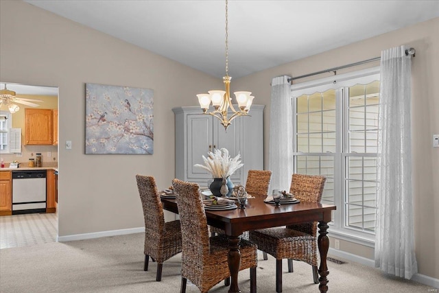 dining room with an inviting chandelier, baseboards, vaulted ceiling, and light colored carpet