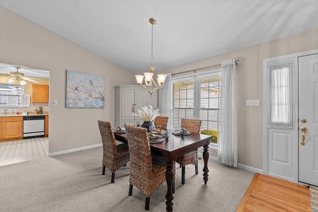 dining area featuring lofted ceiling, light carpet, a notable chandelier, and baseboards