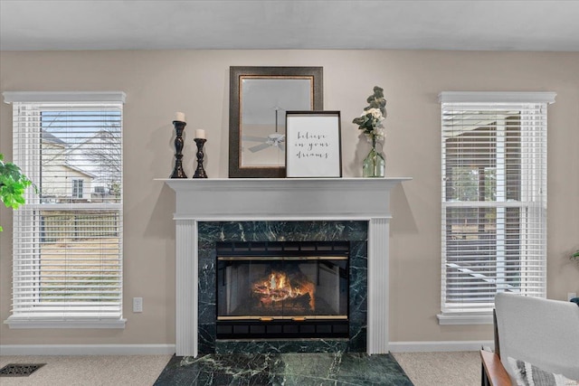 details with baseboards, a premium fireplace, and visible vents