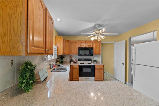 kitchen with freestanding refrigerator, a sink, ceiling fan, range with electric cooktop, and black microwave