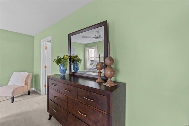 living area featuring baseboards and light colored carpet