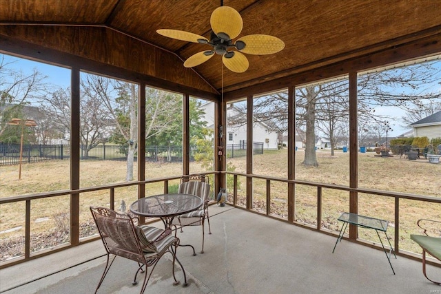 unfurnished sunroom featuring lofted ceiling, wooden ceiling, and a ceiling fan