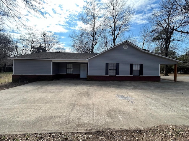 ranch-style home with concrete driveway