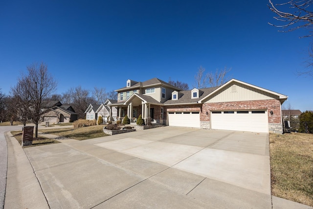 view of front of property featuring an attached garage, driveway, and brick siding