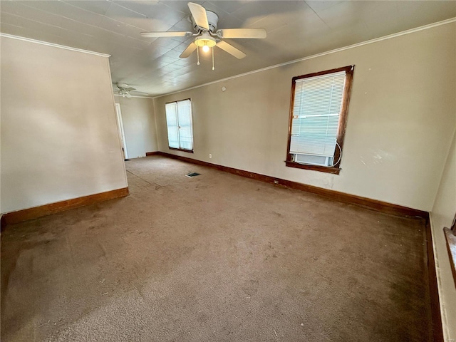 unfurnished room with baseboards, visible vents, a ceiling fan, crown molding, and carpet flooring