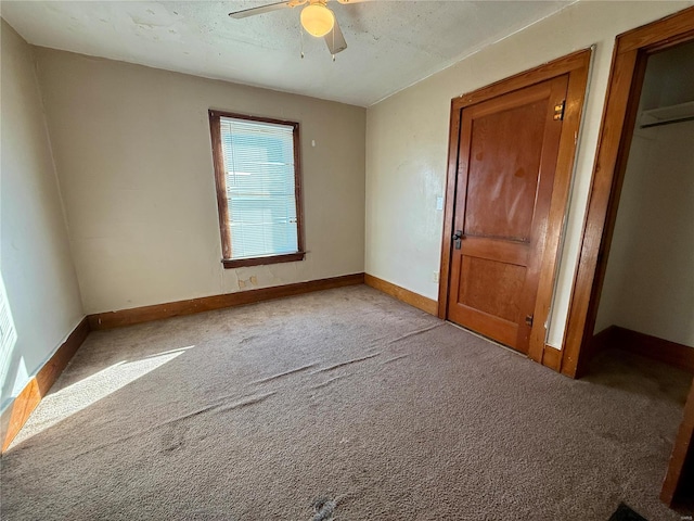 unfurnished bedroom with carpet, baseboards, and a ceiling fan