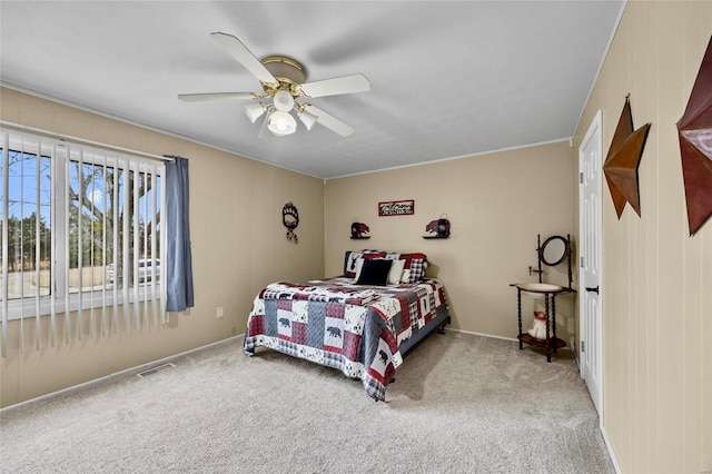 carpeted bedroom featuring visible vents and a ceiling fan