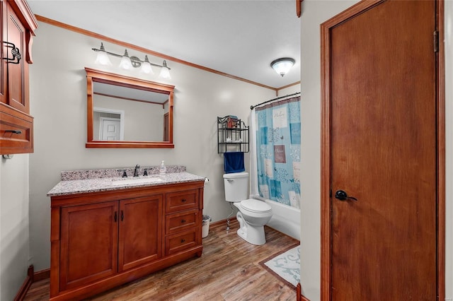 full bath featuring toilet, wood finished floors, vanity, ornamental molding, and shower / tub combo with curtain