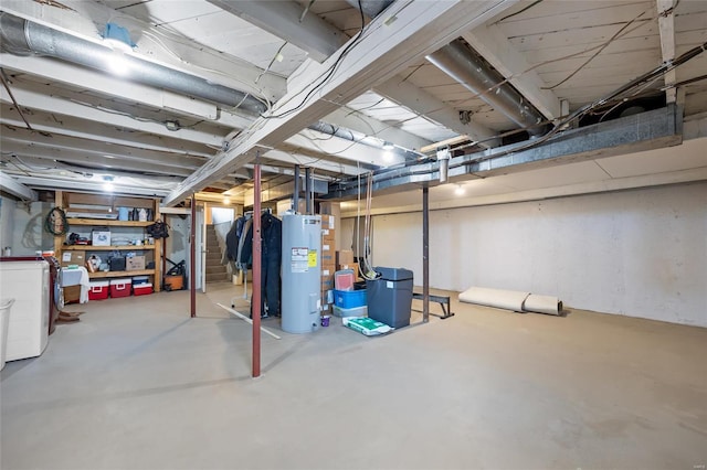 unfinished below grade area featuring water heater and washer / clothes dryer