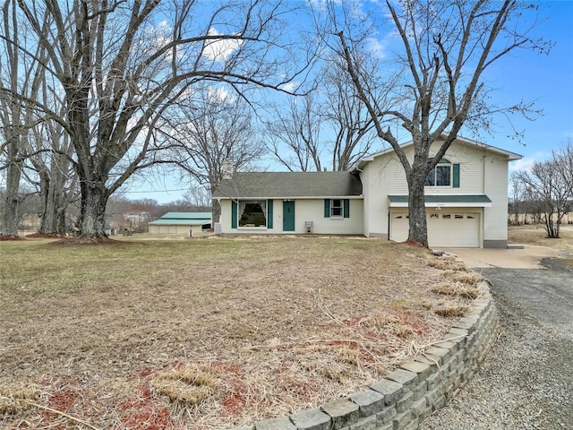 view of front facade with concrete driveway, an attached garage, and a front yard