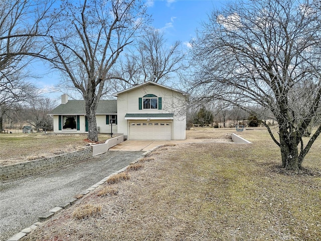 view of front facade with an attached garage, a chimney, and concrete driveway