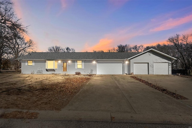 ranch-style home featuring a garage and concrete driveway