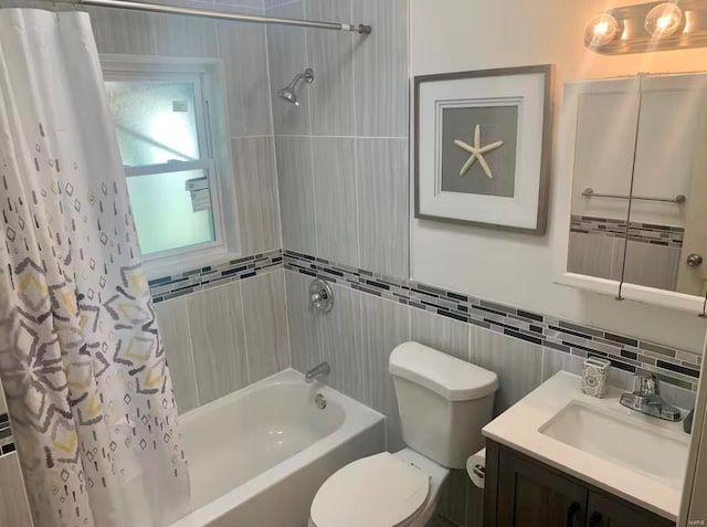 bathroom featuring toilet, shower / tub combo, vanity, and tile walls